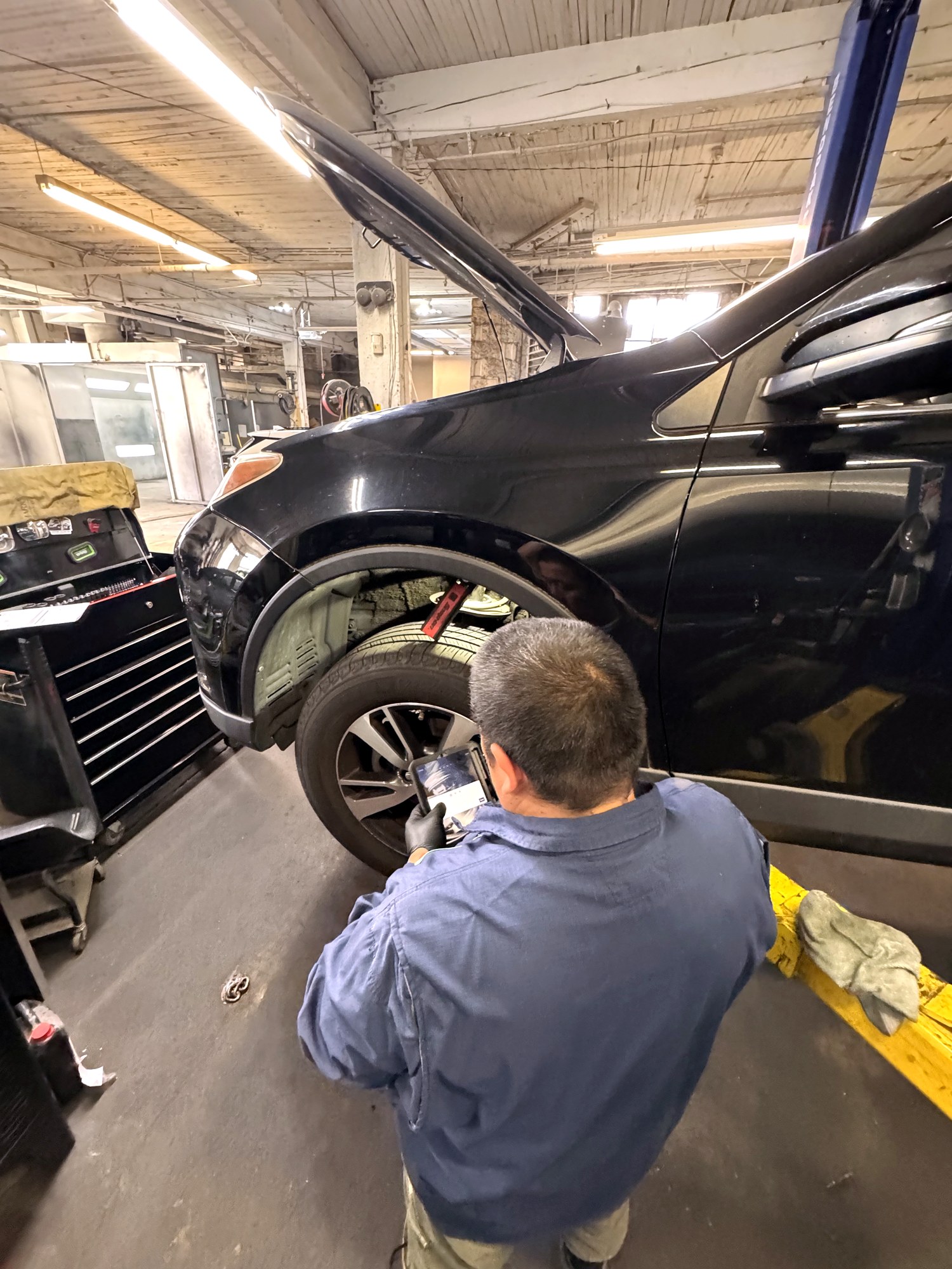 Technician running a digital inspection at the wheel